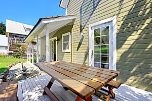 Green olive exterior paint of clapboard siding house