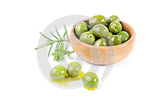 Green olives and aromatic herbs isolated on white background.