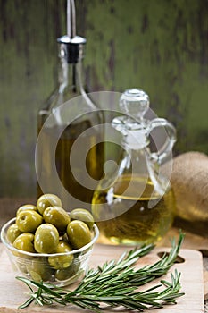 Green Olives and Bottles of Olive Oil