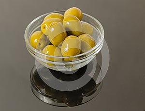 Green olives in bowl isolated