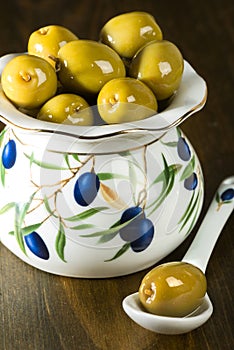 Green olives in porcelain vase