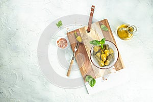 Green olives stuffed with cucumbers on a wooden board. banner, menu, recipe place for text, top view