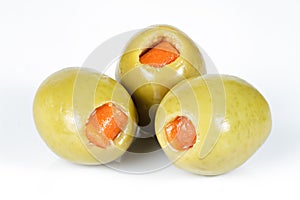 Green olives stuffed with red paprika isolated on white.