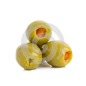 Green olives stuffed with red paprika isolated on white