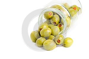 Green olives stuffed with red paprika isolated on white.