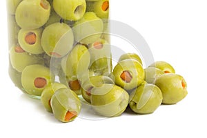 Green olives stuffed with red paprika isolated on white.