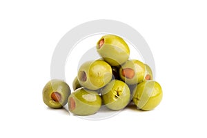 Green olives stuffed with red paprika isolated on white.