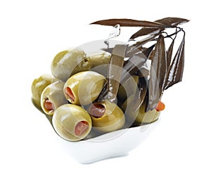 Green olives stuffed with red paprika isolated on white