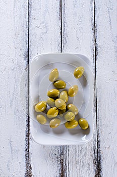 Green olives on a white plate