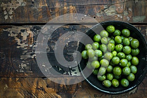 green olives on wooden background