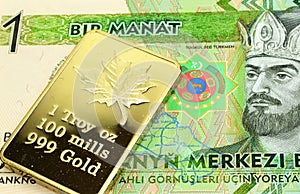 A green one manat bill from Turkmenistan with a gold bar in macro