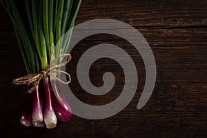 Green onions on wooden table