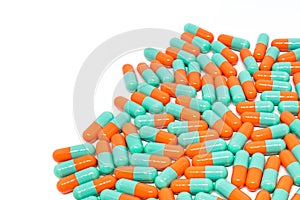Green orange color pills capsule on white background