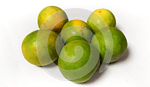 Green orange fruits symmetrically in the middle on a white background