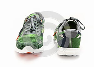 Green and orange running shoes with laces isolated on white studio shot