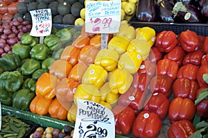 Green, Orange, Yellow, Red, Bell Peppers Displayed At Market photo