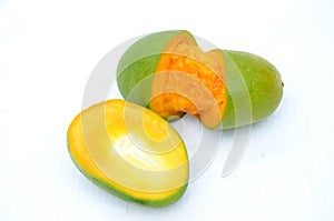 The green orenge slice half cutt mango isolated on white background photo