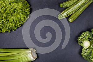 Green organic vegetables on blackboard background