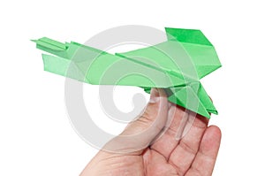 Green origami plane in the hand flying