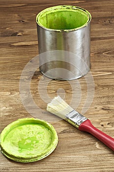 Close-up of a green paint can and brush