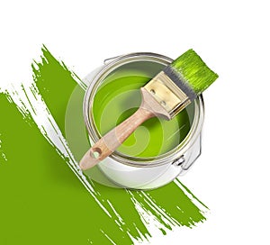 Green paint tin can with brush on top on a white background with green strokes