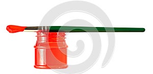 Green paintbrush on red paint can