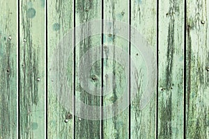 Green painted wooden wall plank perpendicular to the frame simple blue paint timber old grungy wood surface texture background