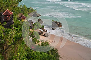 Green palm stone tropical paradise beach with white sand and coco palms tree beautiful wave