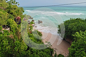 Green palm stone tropical paradise beach with white sand and coco palms tree beautiful wave