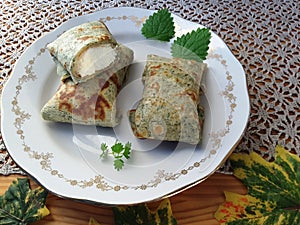 Green pancakes stuffed with cottage cheese