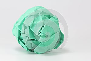 Green paper balls on gray background