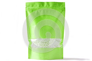 Green paper doypack stand up bio pouch with window zipper on white background filled with rice