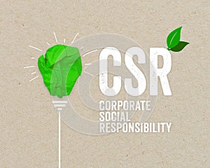 Green paper light bulb metaphor for recycling and acronym CSR - corporate social responsibility renewable energy green climate con