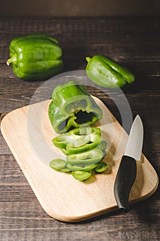 green paprika cut on a wooden board/ fresh green pepper paprika cut on a wooden board