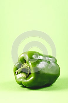 Green paprika pepper over green background /Green paprika close-up. Green paprika pepper over green background