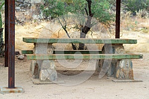 Green park bench in sabino national park in the hills of tuscon arizona for picnics and lunch for travelers and hikers