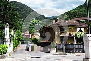 Green park in Italy. Beautiful view of the houses and the street in the Italian city of Pisogne