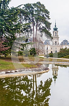 Green park with a view of the Beautiful baroque Festetics Castle in Keszthely Hungary, reflection in the lake pond
