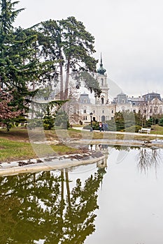 Green park with a view of the Beautiful baroque Festetics Castle in Keszthely Hungary, reflection in the lake pond