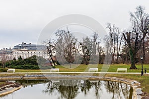 Green park with a view of the Beautiful baroque Festetics Castle in Keszthely Hungary, reflection in the lake pond