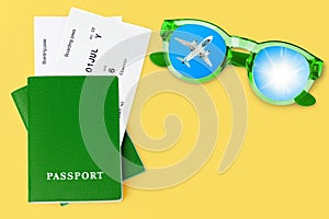 Green passport, boarding pass, flight ticket, sunglasses, airplane, sun blue sky, summer holiday, vacation, travel