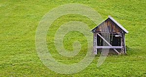 Green pasture with old wooden barn