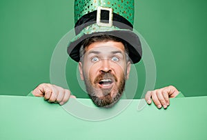 Green patricks background. Man in Patrick`s suit smiling. photo