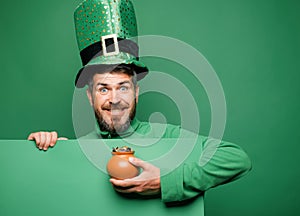 Green patricks background. Man in Patrick's suit smiling. Man in Saint Patrick's Day leprechaun party hat having photo