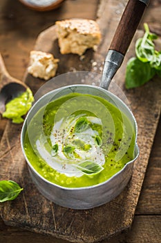 Green pea creamy soup in pot