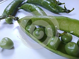 Green pea seeds in a white background