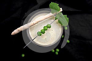 Green pea soup with Grissini on dark rustic background