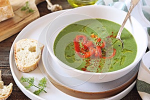 Green pea soup with spinach, olive oil, red grilled bell pepper and dill dressing