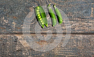 Green pea stalks on a wooden texture. Boards. Cooking, gardening, vegetable garden