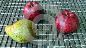 Green pear and two red apples